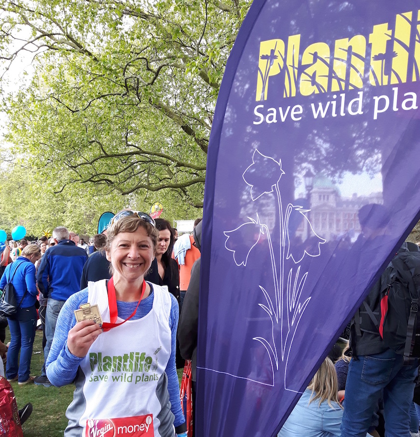 Lady in Plantlife Running Vest with Medal.