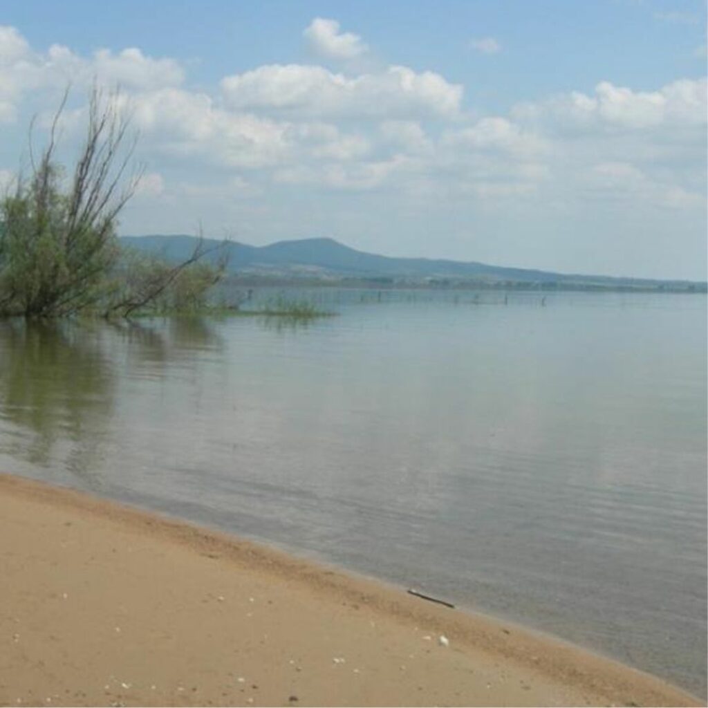 Edge of water course with mountains in distance