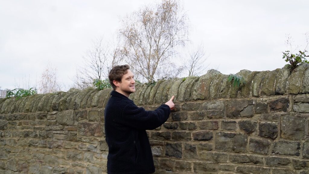 Rob Hodgson looking for lichens on a wall