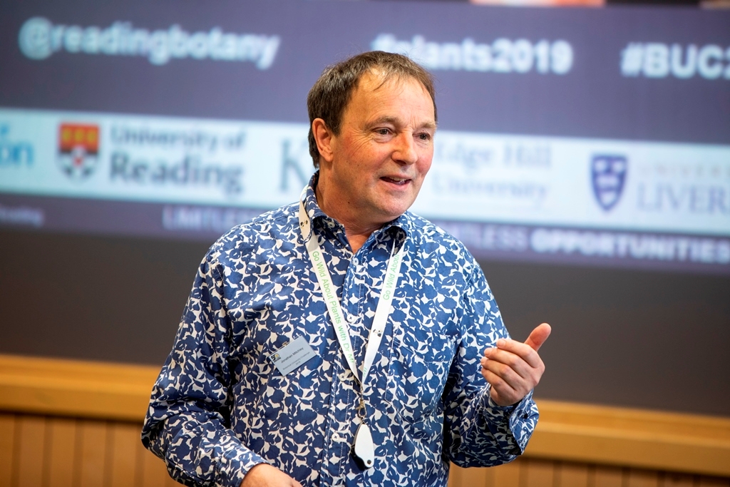 A professor stands in a lecture hall addressing the class