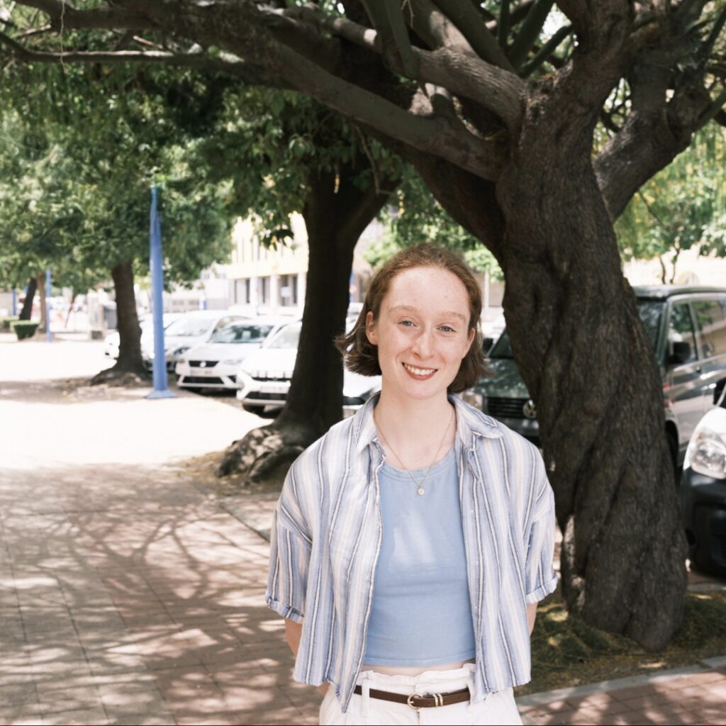 Photo shows a woman stood on a tree lined street